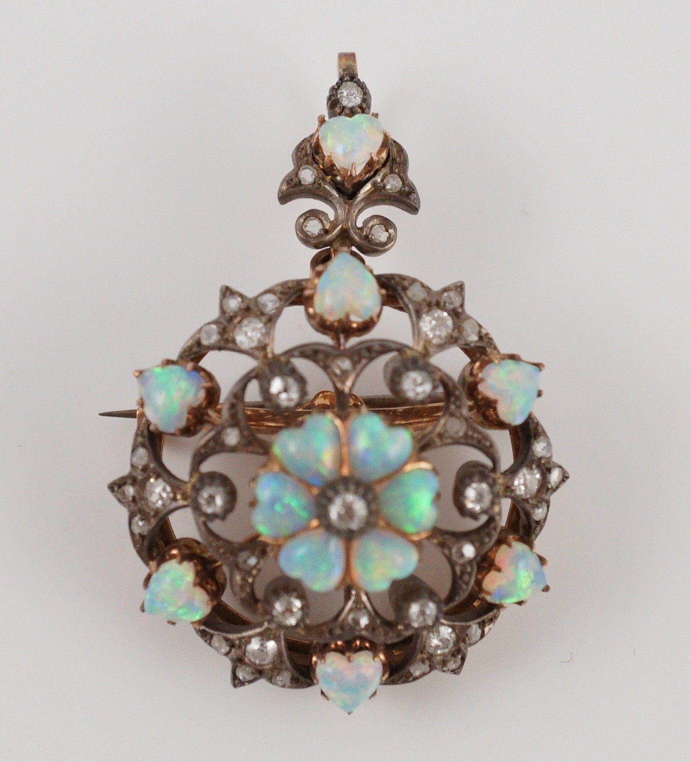 A late Victorian gold silver and diamond circular cluster pendant brooch, 3.5cm, gross 17.5 grams